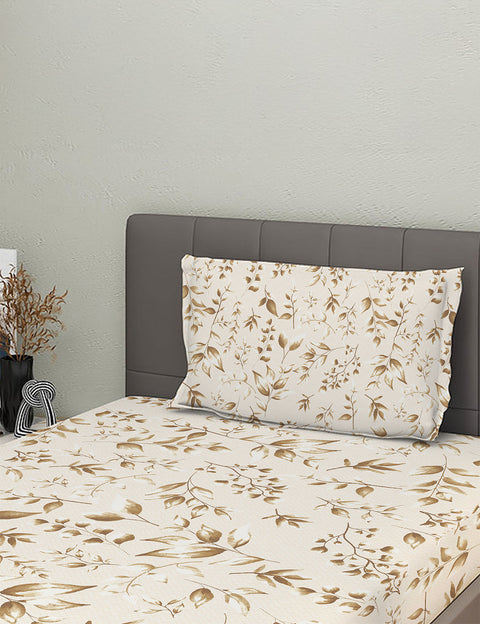 Floral-patterned bedspread and pillow on a bed with a gray headboard.