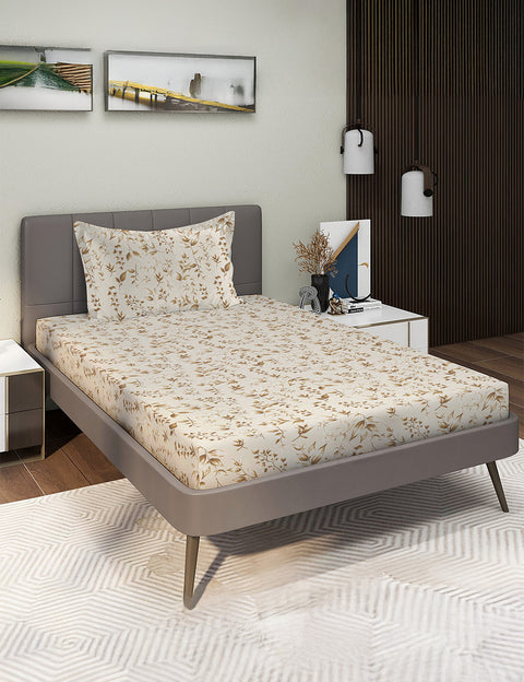 Bedroom with a bed featuring a floral-patterned bedspread, nightstands, and wall art.