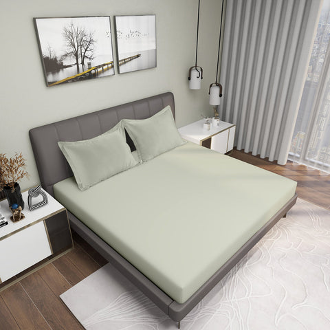 Warm Sand Colour Bedsheet With 2 Pillows on Charcoal Coloured Bed with two photo frames