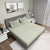 Warm Sand Colour Bedsheet With 2 Pillows on Charcoal Coloured Bed with two photo frames