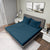 Gres Legion Blue Color Bedsheet With 2 Pillows under a Charcoal Color Bed With Light Lamps on One Side And Photo Frames