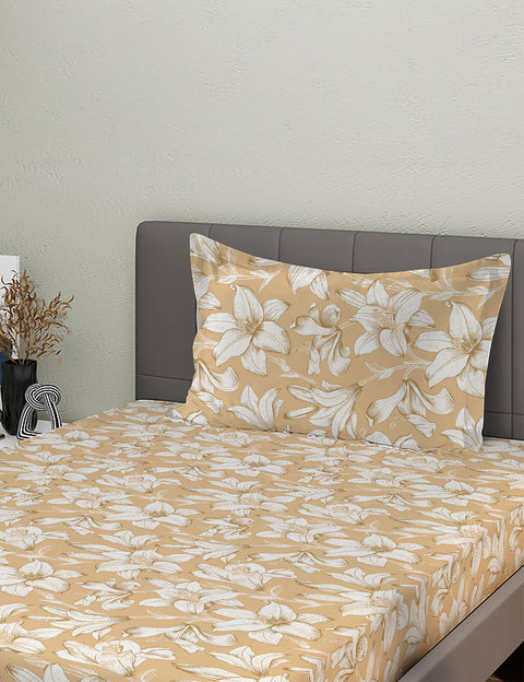 Floral patterned bedspread on a bed with a gray headboard.