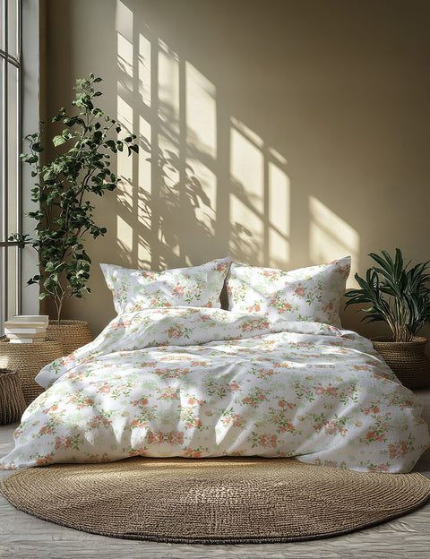 Floral bedding set on a bed with plants and sunlight in the background
