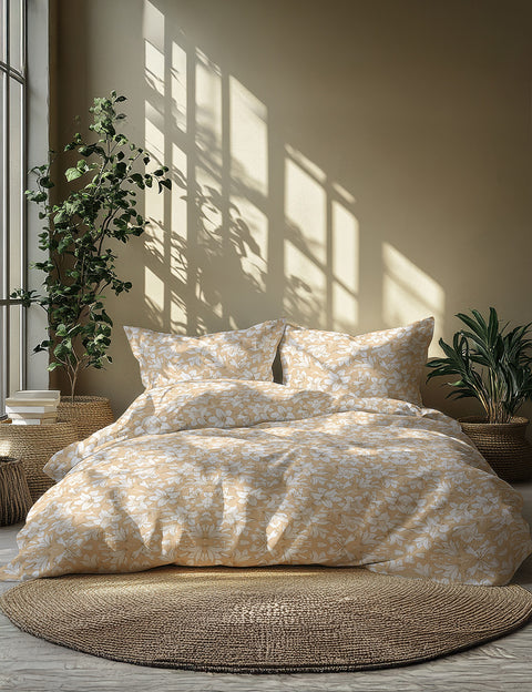 Floral bedding set on a bed with plants and sunlight in the background