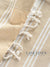 Close-up of a beige fabric with white embroidery and 'Lane Linen' branding.