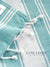 Close-up of a turquoise and white striped fabric with 'Lane Linen' branding.