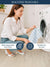 Woman washing a kitchen cloth of white & blue color striped with a washing machine, showing care instructions