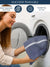 A Woman holding a blue color whitr striped towel in front of a washing machine with washing and tumble drying instructions.