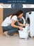 Woman washing clothes in a bucket with text on machine washability and care instructions.