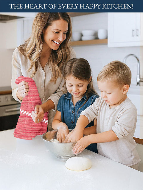 A Woman Holding Red Color Kitchen Towel  and two children in a kitchen preparing food together.