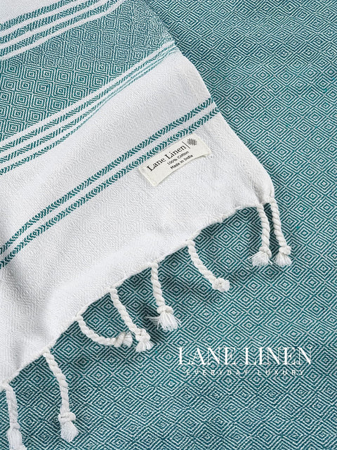 Baltic and white towel on a matching background, featuring Lane Linen branding.