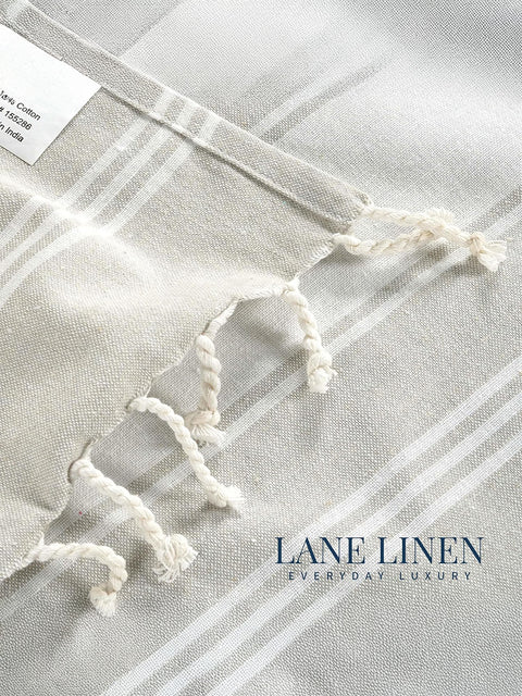 Grey towel with Printed 'Lane Linen' branding on a light gray background