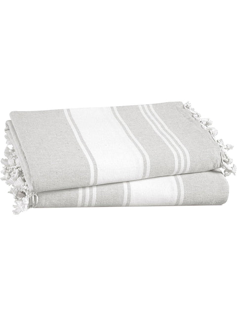 Two folded gray and white striped towels with tassels on a white background