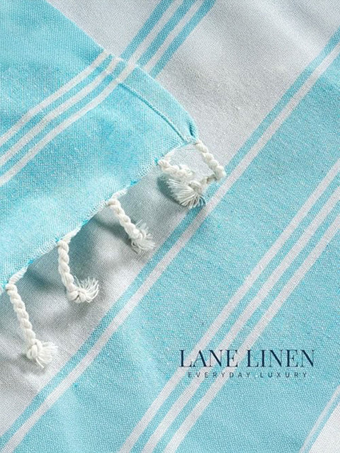 Close-up of a aqua and white striped towel with featuring of 'Lane Linen' branding.