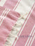 Close-up of pink and white striped fabric with 'Lane Linen' branding.
