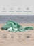 Green towel on sand with features listed such as quick dry, sand proof, breathable, machine washable, absorbent, compact, versatile,stylish design