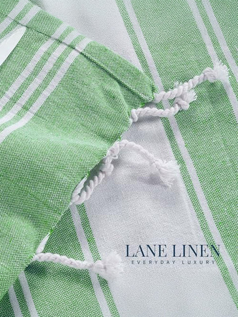 Close-up of green and white checkered fabric with 'Lane Linen' branding.