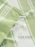 Close-up of Lime and white checkered fabric with 'Lane Linen' branding.