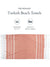 Turkish beach towel with striped pattern on a white background, featuring text about size and quantity.