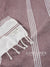 Red towel with White stripes on a patterned fabric background, featuring the brand 'Lane & Linen'.