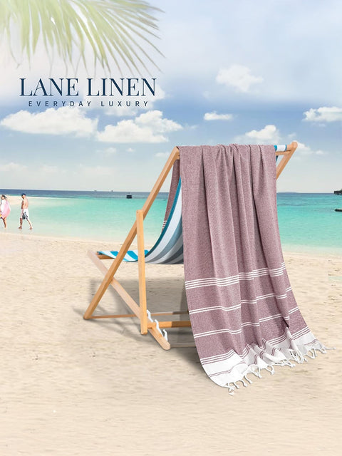 Towel draped over a deck chair on a beach with 'Lane Linen' branding