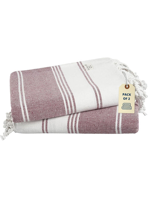 Folded towel with striped pattern and a tag on a white background