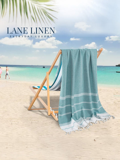 Beach towel draped over a beach chair with 'Lane Linen' branding on a beach background.