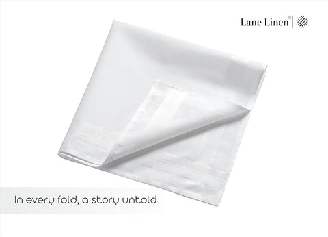 Folded white linen sheet with 'Lane Linen' branding on a white background and describing as in every fold a story untold
