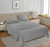 A silver-colored Lane Linen 500TC 100% Cotton Caligo King Flat Satin Bedsheet set displayed on a bed in a home setting, including one flat sheet and two pillowcases.