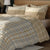 Brown Floral Geometric Pattern Bedsheet With Pillows On A Wooden Bed