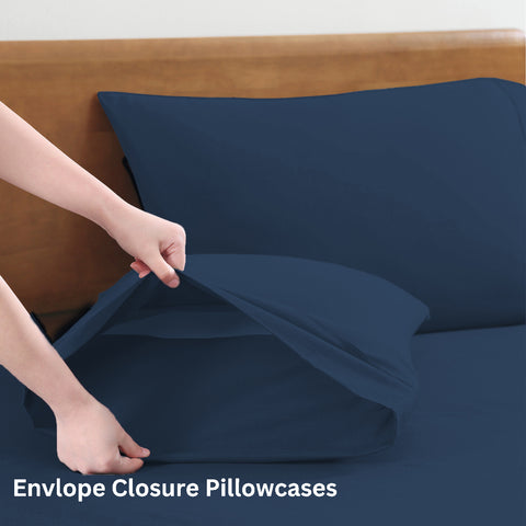 King sized bedsheets wirh 2 Pillows of Blue Color on A Wooden Bed