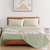 King sized bedsheet, 2 pillows on a wooden bed with photo frame in background