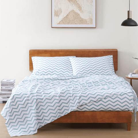 Single bedsheet qith 2 pillows on a wooden bed with photoframe in the background