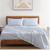 Polka Dot Blue Color Bedsheet With 2 Similar Color Pillows On A Wooden Bed