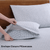 2 Polka Dot Blue Color Pillows with Bedsheet On A Wooden Bed