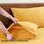 King sized bedsheet with 2 pillows of coccoon color ona wooden bed 