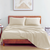 King Size Bedsheet With 2 Pillows of Ivory Colour On A Wooden Bed With Photoframe in Background